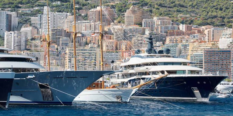 Luxury yachts docked in a harbor, symbolizing the 1% mindset and the pursuit of wealth and success.