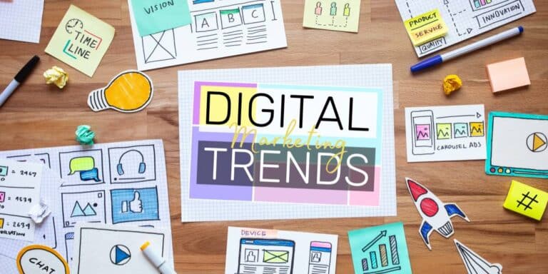 Digital marketing trends written on a piece of paper, surrounded by other pieces of marketing brainstorming material.