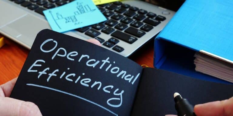 Operational efficiency written in a black notebook with a silver sharpie.