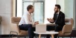 Two business professionals discussing strategies to improve their b2b sales funnel during a coaching session
