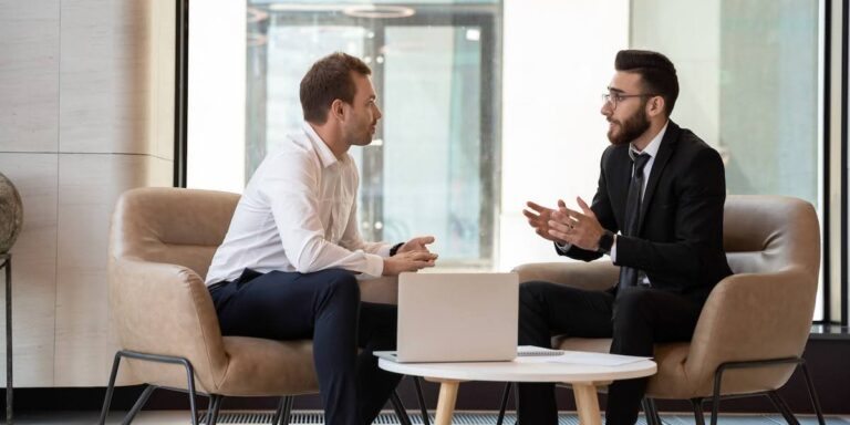 Two business professionals discussing strategies to improve their b2b sales funnel during a coaching session
