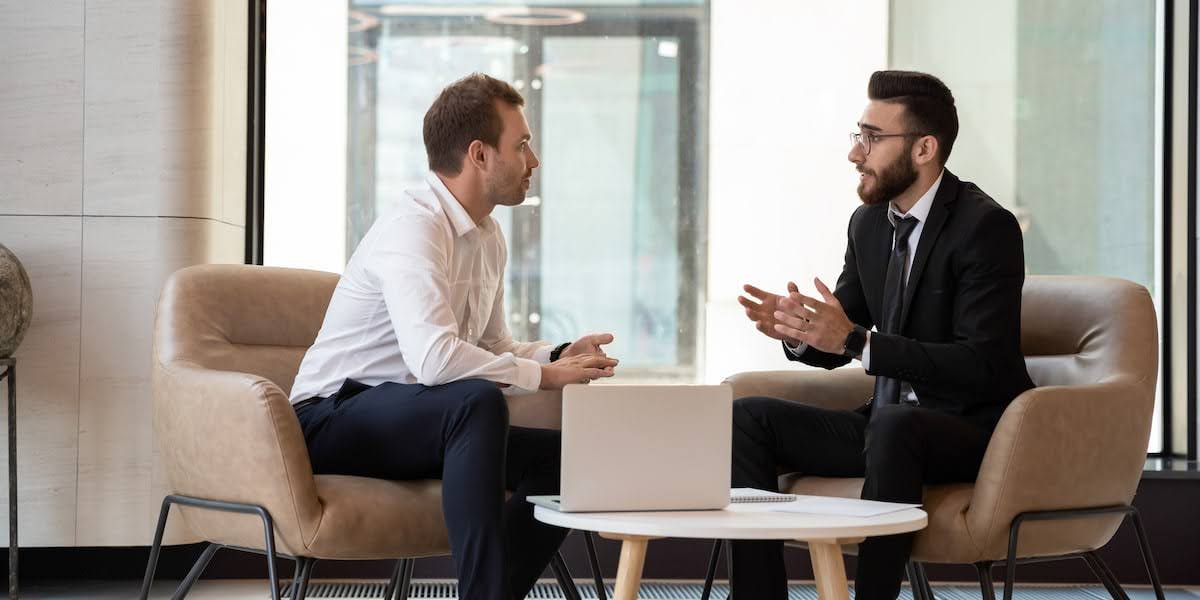 Two business professionals discussing strategies to improve their b2b sales funnel during a coaching session