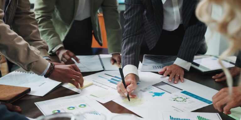 Team analyzing charts and graphs during a business budgeting meeting for 2026 planning