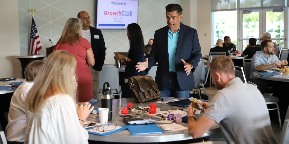 Business coach leading group discussion during business growth workshop