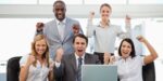 Business team celebrating success after achieving clear goals vs objectives alignment in workplace strategy