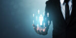 Business leader demonstrating how to develop leadership skills by selecting and managing team members with digital icons floating above open hand
