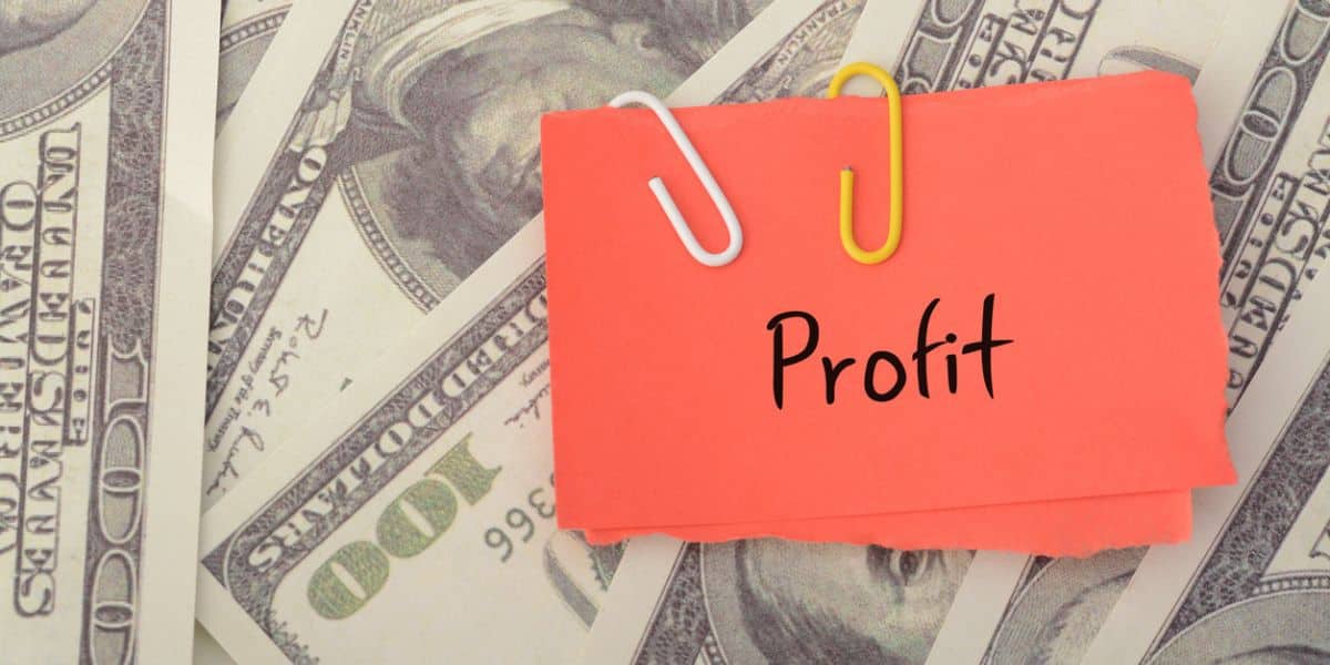 A stack of money with a sticky note that says "profit" as a display of what profit looks like after calculating how to find gross profit.