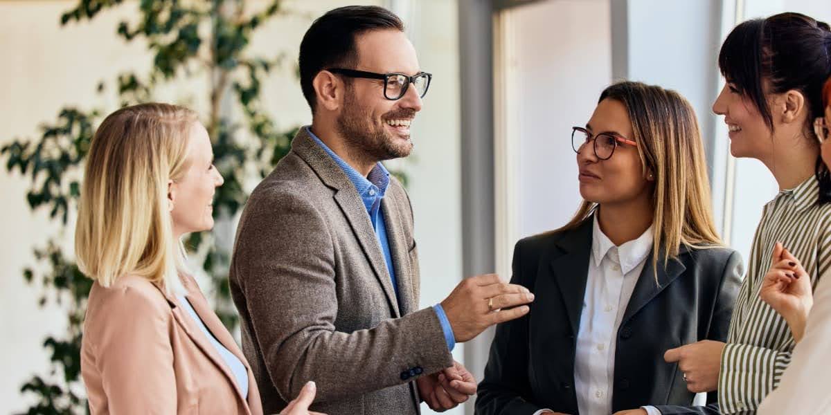 Business professionals in discussion referencing leadership development trends during a workplace conversation