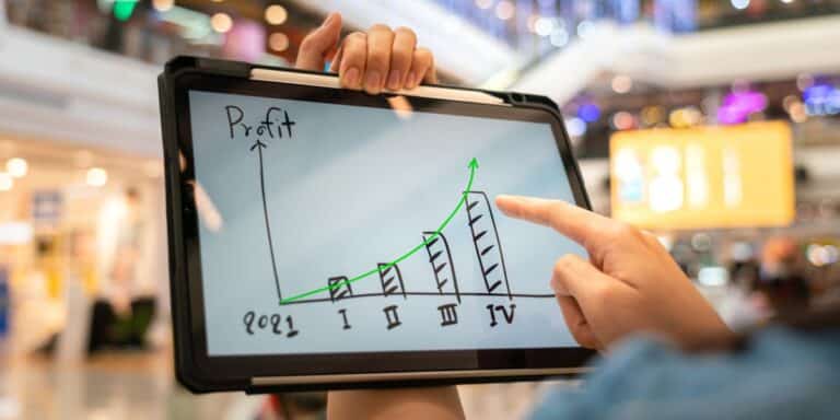 A business woman draws a graph to determine what is a good profit margin for small business.