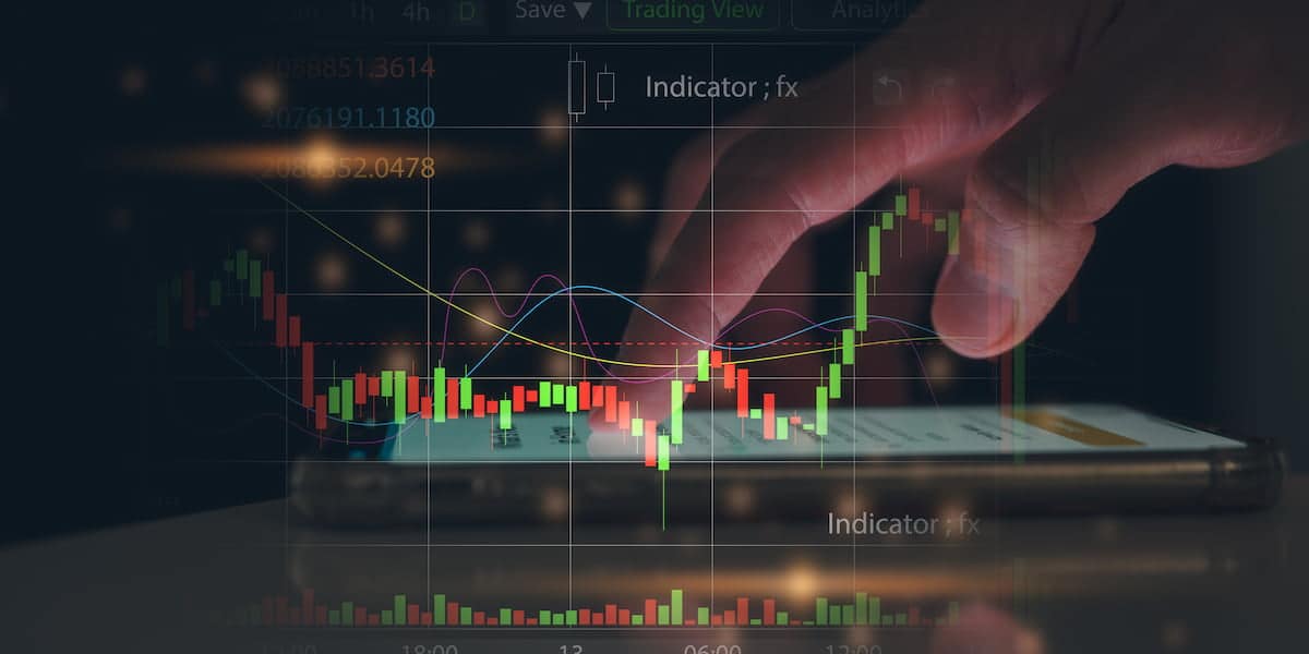 Financial graph displayed on a mobile device with hand interacting, illustrating the concept of analyzing the net profit margin ratio for business insights.